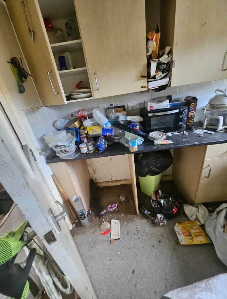 Extremely cluttered and dirty kitchen needing professional hoarder clearance or house rubbish removal.